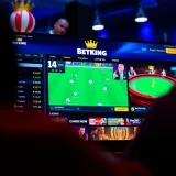 Mobile phone screen displaying BetKing login interface with secure access features